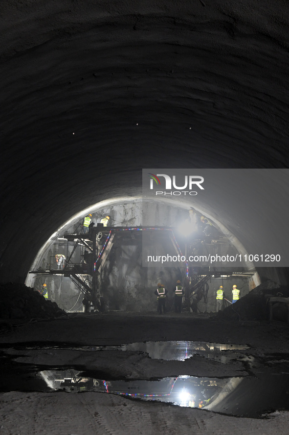 Workers are preparing for blasting at the exit of the Tiemengguan tunnel in Bazhou, Xinjiang province, China, on March 9, 2024. 