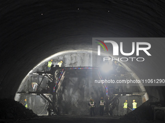 Workers are preparing for blasting at the exit of the Tiemengguan tunnel in Bazhou, Xinjiang province, China, on March 9, 2024. (