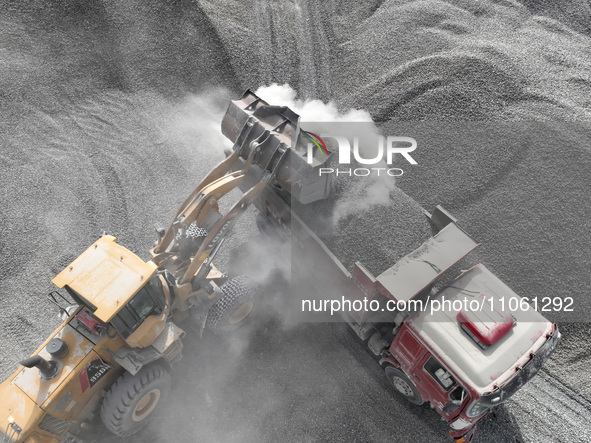 Workers are preparing materials for tunnel reinforcement at the exit of the Tiemengguan tunnel in Bazhou, Xinjiang province, China, on March...