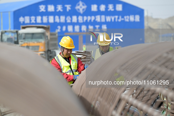 Workers are inspecting steel cage piles at the exit of the Tiemengguan tunnel in Bazhou, Xinjiang Province, China, on March 9, 2024. 