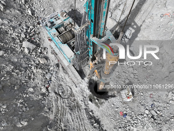 Workers are working on the pile foundation of bridge piers at the exit of the Tiemengguan tunnel in Bazhou, Xinjiang Province, China, on Mar...