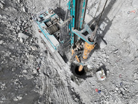 Workers are working on the pile foundation of bridge piers at the exit of the Tiemengguan tunnel in Bazhou, Xinjiang Province, China, on Mar...