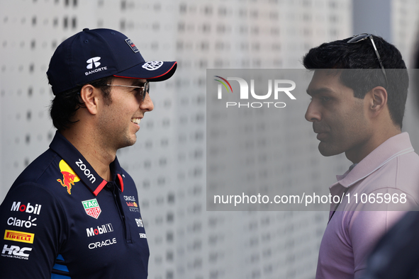 Sergio Perez of Red Bull Racing and Karun Chandhok before first practice ahead of the Formula 1 Saudi Arabian Grand Prix at Jeddah Corniche...