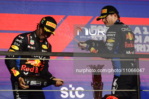 Sergio Perez and Max Verstappen of Red Bull Racing at the podium after the Formula 1 Saudi Arabian Grand Prix at Jeddah Corniche Circuit in...