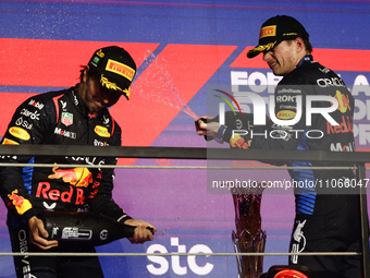 Sergio Perez and Max Verstappen of Red Bull Racing at the podium after the Formula 1 Saudi Arabian Grand Prix at Jeddah Corniche Circuit in...