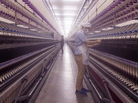 A worker is operating an intelligent production line at a textile company in Taizhou, Jiangsu Province, China, on March 12, 2024. (