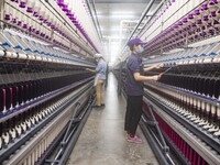 A worker is operating an intelligent production line at a textile company in Taizhou, Jiangsu Province, China, on March 12, 2024. (