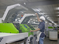 A worker is operating an intelligent production line at a textile company in Taizhou, Jiangsu Province, China, on March 12, 2024. (