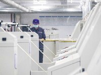 A worker is operating an intelligent production line at a textile company in Taizhou, Jiangsu Province, China, on March 12, 2024. (