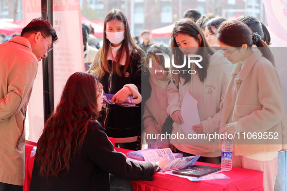 Female college students are looking for jobs at the 2024 Women's Campus job fair in Huaibei, Anhui province, China, on March 12, 2024. 