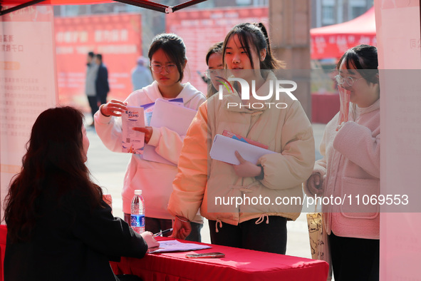 Female college students are looking for jobs at the 2024 Women's Campus job fair in Huaibei, Anhui province, China, on March 12, 2024. 