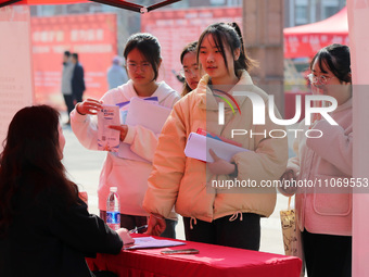 Female college students are looking for jobs at the 2024 Women's Campus job fair in Huaibei, Anhui province, China, on March 12, 2024. (