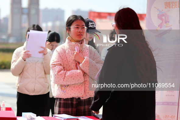 Female college students are looking for jobs at the 2024 Women's Campus job fair in Huaibei, Anhui province, China, on March 12, 2024. 