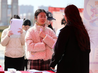 Female college students are looking for jobs at the 2024 Women's Campus job fair in Huaibei, Anhui province, China, on March 12, 2024. (