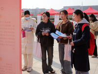 Female college students are looking for jobs at the 2024 Women's Campus job fair in Huaibei, Anhui province, China, on March 12, 2024. (