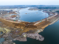 Construction workers and large machinery are working on the Heilongtan Reservoir reinforcement project in Lianyungang, China, on March 12, 2...