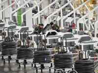 Workers are checking equipment operation at a digital intelligent production workshop at a hardware manufacturing company in Handan, North C...