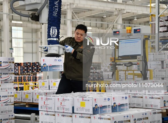 A worker is loading and unloading goods at a smart storage workshop at a hardware manufacturing company in Handan, China, on March 12, 2024....