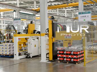 Workers are operating equipment in a digital intelligent workshop at a hardware manufacturing company in Handan, China, on March 12, 2024. (