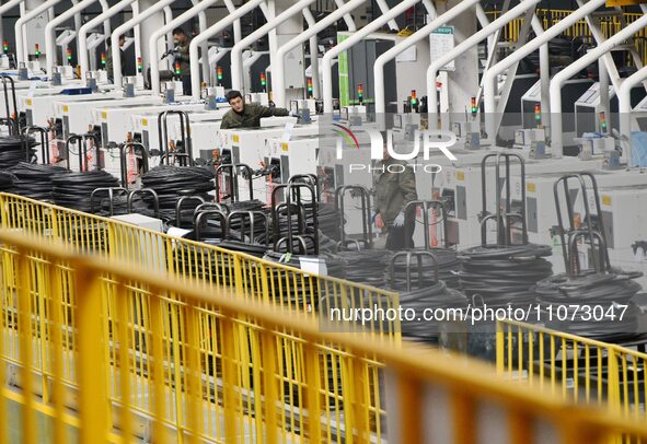 A worker is operating equipment in a digital intelligent production workshop at a hardware manufacturing company in Handan, North China's He...