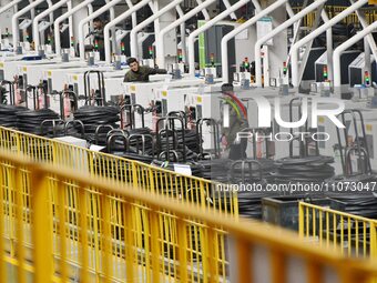 A worker is operating equipment in a digital intelligent production workshop at a hardware manufacturing company in Handan, North China's He...