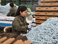 Workers are producing drill tail wire products for export overseas in a digital intelligent production workshop at a hardware manufacturing...