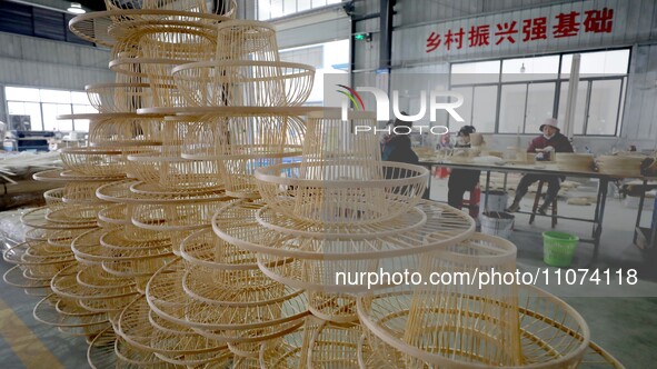 Workers are working on a production line in a craft company's workshop in Liuzhou, China, on March 10, 2024. 