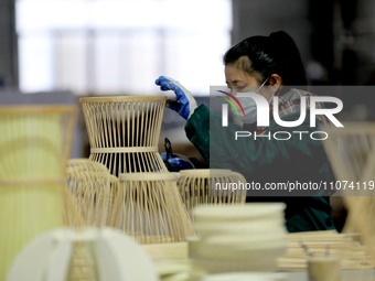 A worker is working on a production line in a craft company's workshop in Liuzhou, China, on March 10, 2024. (