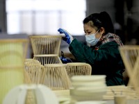 A worker is working on a production line in a craft company's workshop in Liuzhou, China, on March 10, 2024. (