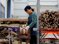 A worker is working on a production line in a craft company's workshop in Liuzhou, China, on March 10, 2024. (