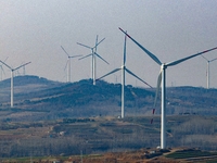 Giant windmills are spinning in the wind at Baoshan Town wind farm in the West Coast New Area of Qingdao, Shandong Province, China, on March...