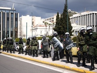 Police is standing in front of the parliament building while demonstrators attend a protest held by 
student associations and educational u...