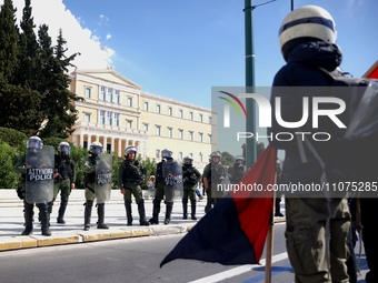 Police is standing in front of the parliament building while demonstrators attend a protest held by 
student associations and educational u...