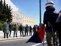 Police is standing in front of the parliament building while demonstrators attend a protest held by 
student associations and educational u...