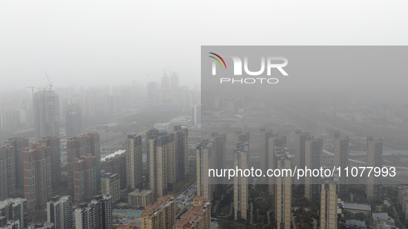 City buildings are looming under smog in Xi'an, Shaanxi Province, China, on March 16, 2024. 