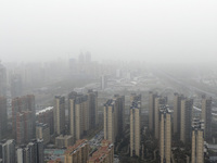 City buildings are looming under smog in Xi'an, Shaanxi Province, China, on March 16, 2024. (