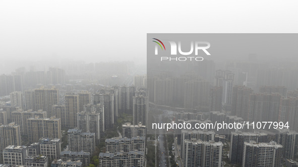 City buildings are looming under smog in Xi'an, Shaanxi Province, China, on March 16, 2024. 