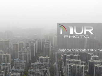 City buildings are looming under smog in Xi'an, Shaanxi Province, China, on March 16, 2024. (