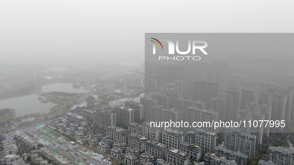 City buildings are looming under smog in Xi'an, Shaanxi Province, China, on March 16, 2024. 