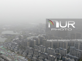 City buildings are looming under smog in Xi'an, Shaanxi Province, China, on March 16, 2024. (