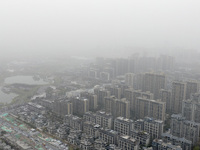 City buildings are looming under smog in Xi'an, Shaanxi Province, China, on March 16, 2024. (