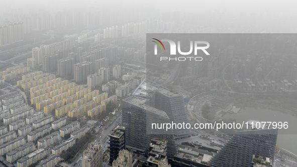 City buildings are looming under smog in Xi'an, Shaanxi Province, China, on March 16, 2024. 