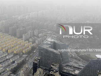 City buildings are looming under smog in Xi'an, Shaanxi Province, China, on March 16, 2024. (