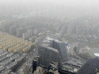 City buildings are looming under smog in Xi'an, Shaanxi Province, China, on March 16, 2024. (