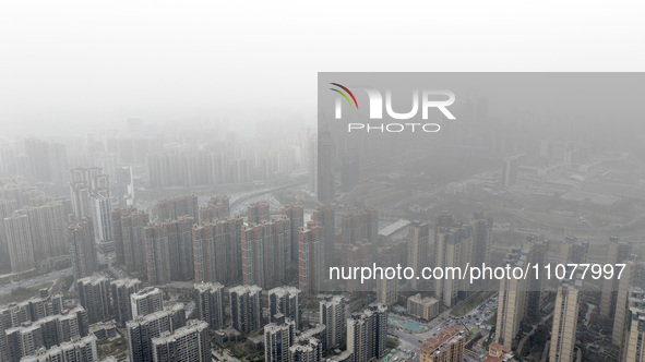 City buildings are looming under smog in Xi'an, Shaanxi Province, China, on March 16, 2024. 