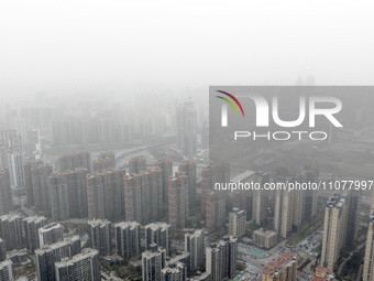 City buildings are looming under smog in Xi'an, Shaanxi Province, China, on March 16, 2024. (