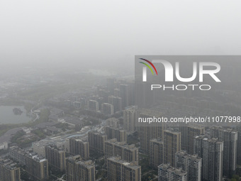 City buildings are looming under smog in Xi'an, Shaanxi Province, China, on March 16, 2024. (