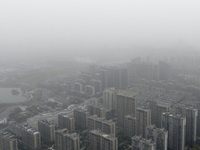 City buildings are looming under smog in Xi'an, Shaanxi Province, China, on March 16, 2024. (