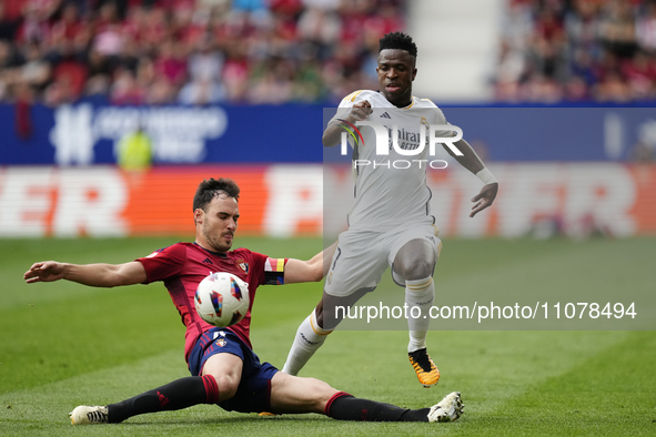Vinicius Junior left winger of Real Madrid and Brazil and Unai Garcia centre-back of Osasuna and Spain compete for the ball during the LaLig...