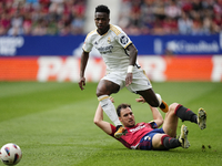Vinicius Junior left winger of Real Madrid and Brazil and Unai Garcia centre-back of Osasuna and Spain compete for the ball during the LaLig...